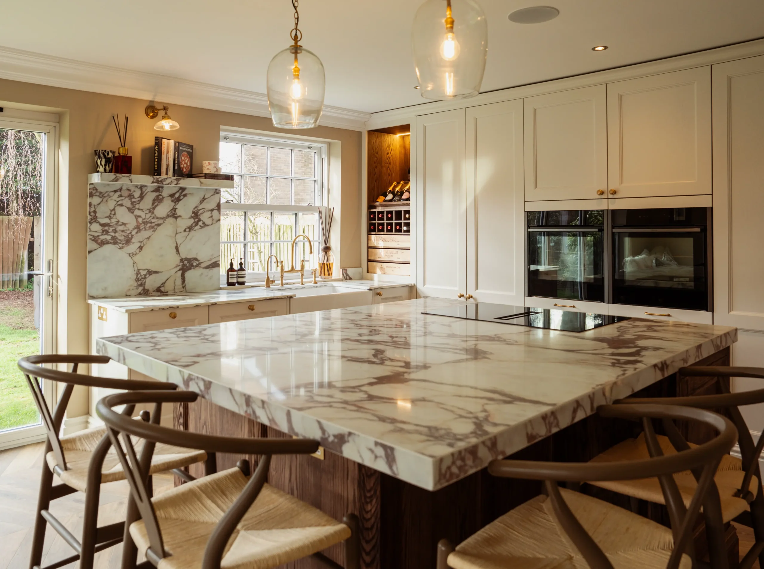 Calacatta Viola worktop surface with deep burgundy veining across a warm ivory base