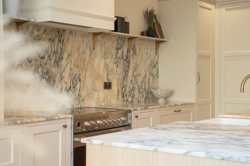 Calacatta Monet marble splashback and worktop beside the cooker in the Sussex kitchen