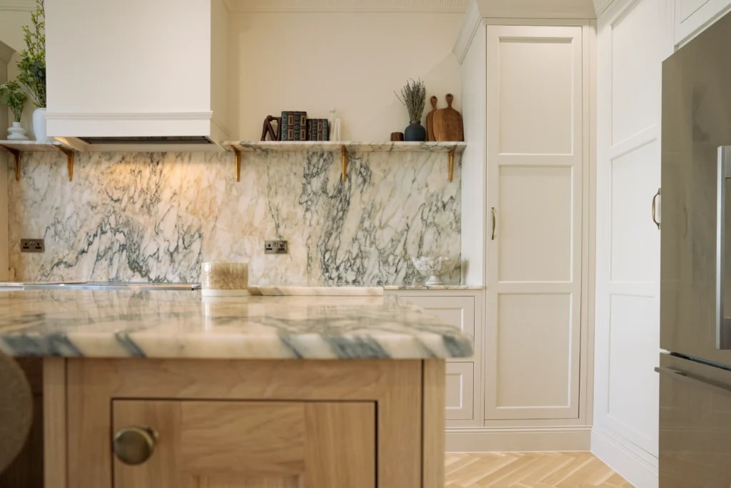 Calacatta Monet marble worktop and splashback along the kitchen cabinets in Sussex