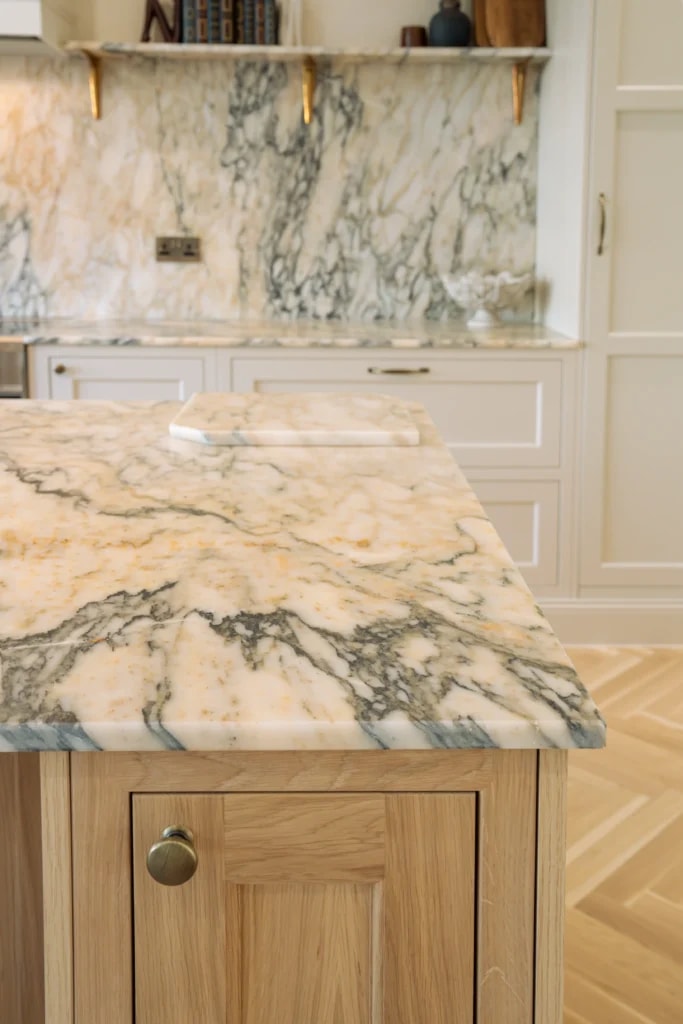 Calacatta Monet marble kitchen island with distinctive veining and matching splashback in Sussex