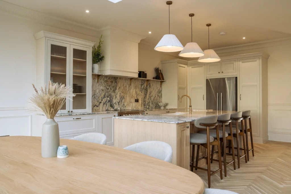 Calacatta Monet marble splashback and worktops beside the dining island in a Sussex kitchen