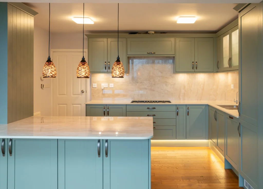 Shaker kitchen with SINTERRA worktops and warm pendant lighting
