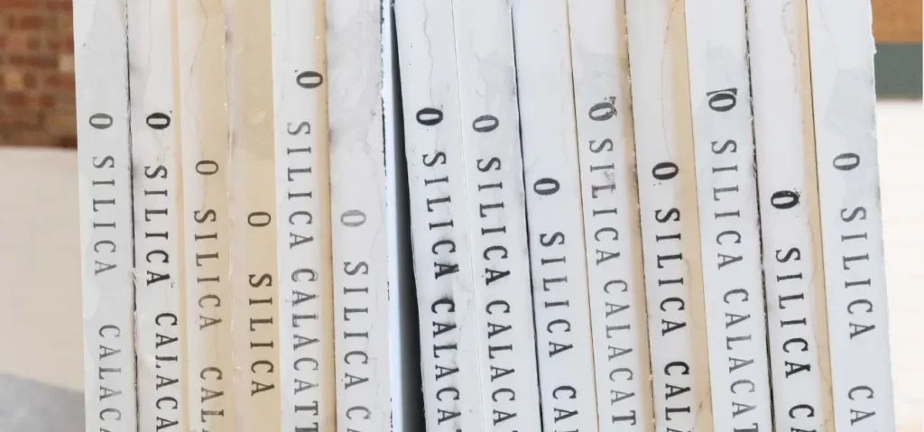 Collection of Mo's StoneX 0% Silica sample books on display