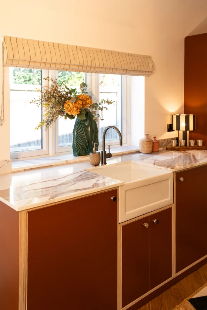 Luxury kitchen with ELORĀ mineral surface worktops and warm details