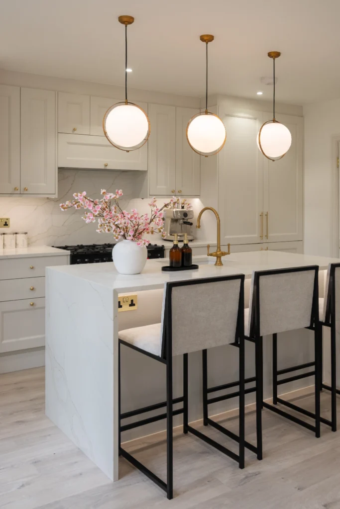 Contemporary white kitchen with ELORĀ worktops and breakfast bar