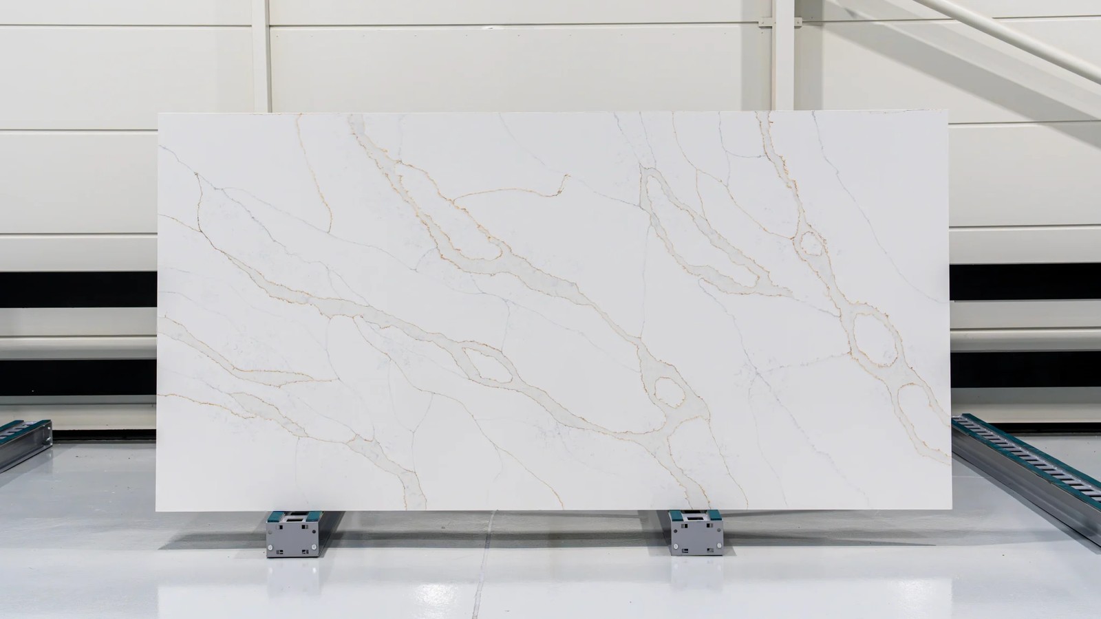 Calacatta Gold white engineered stone slab display with grey and gold veining