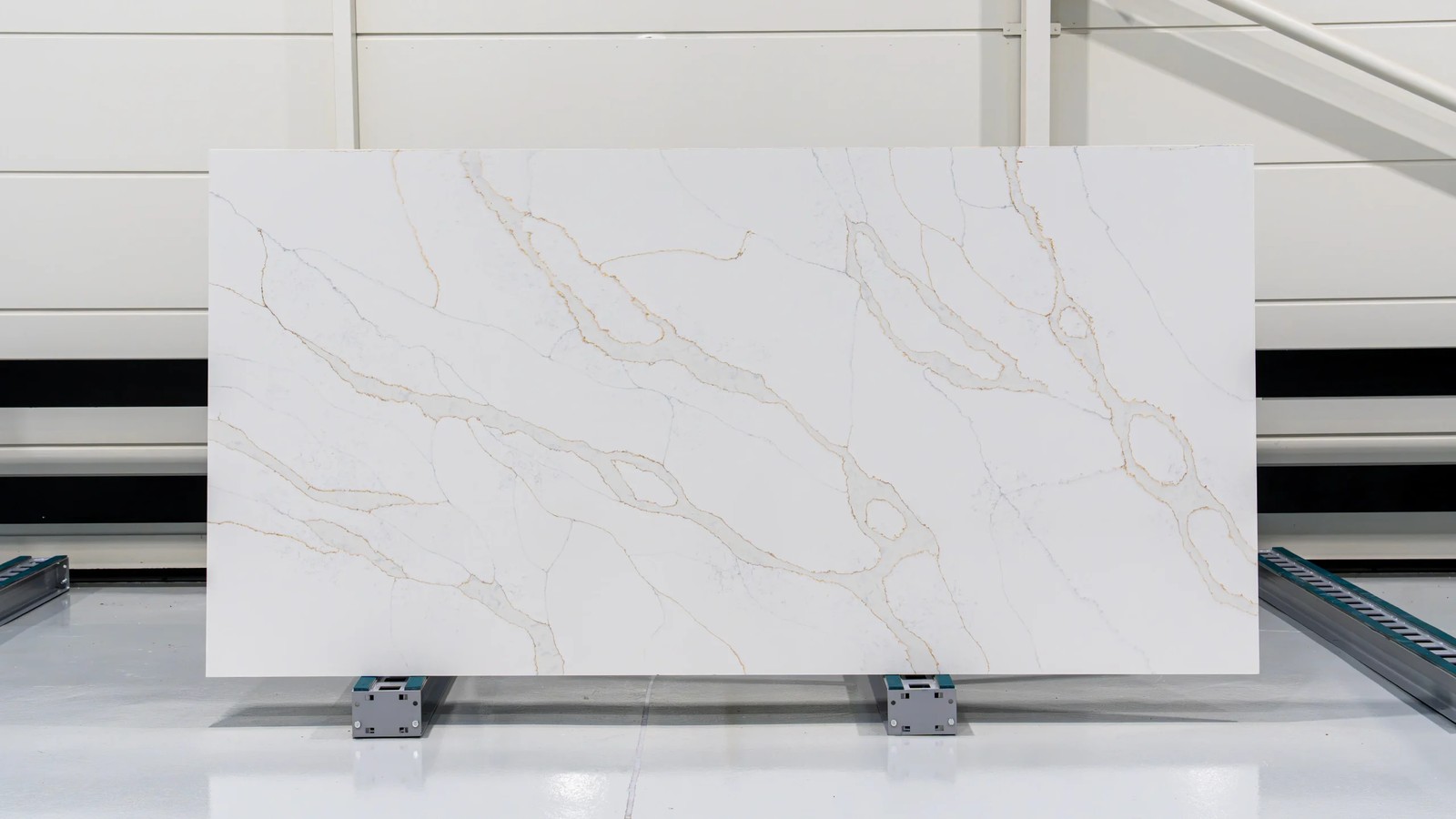 Calacatta Gold white engineered stone slab display with grey and gold veining