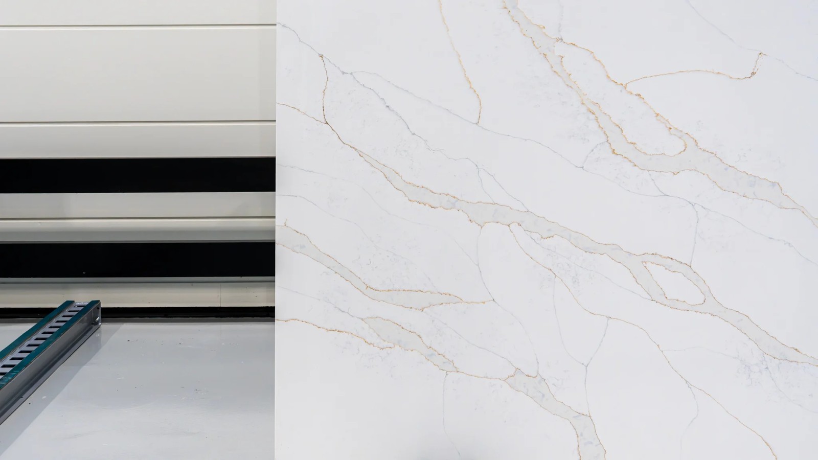 Calacatta Gold white engineered stone slab angled view with natural-looking grey and gold veining