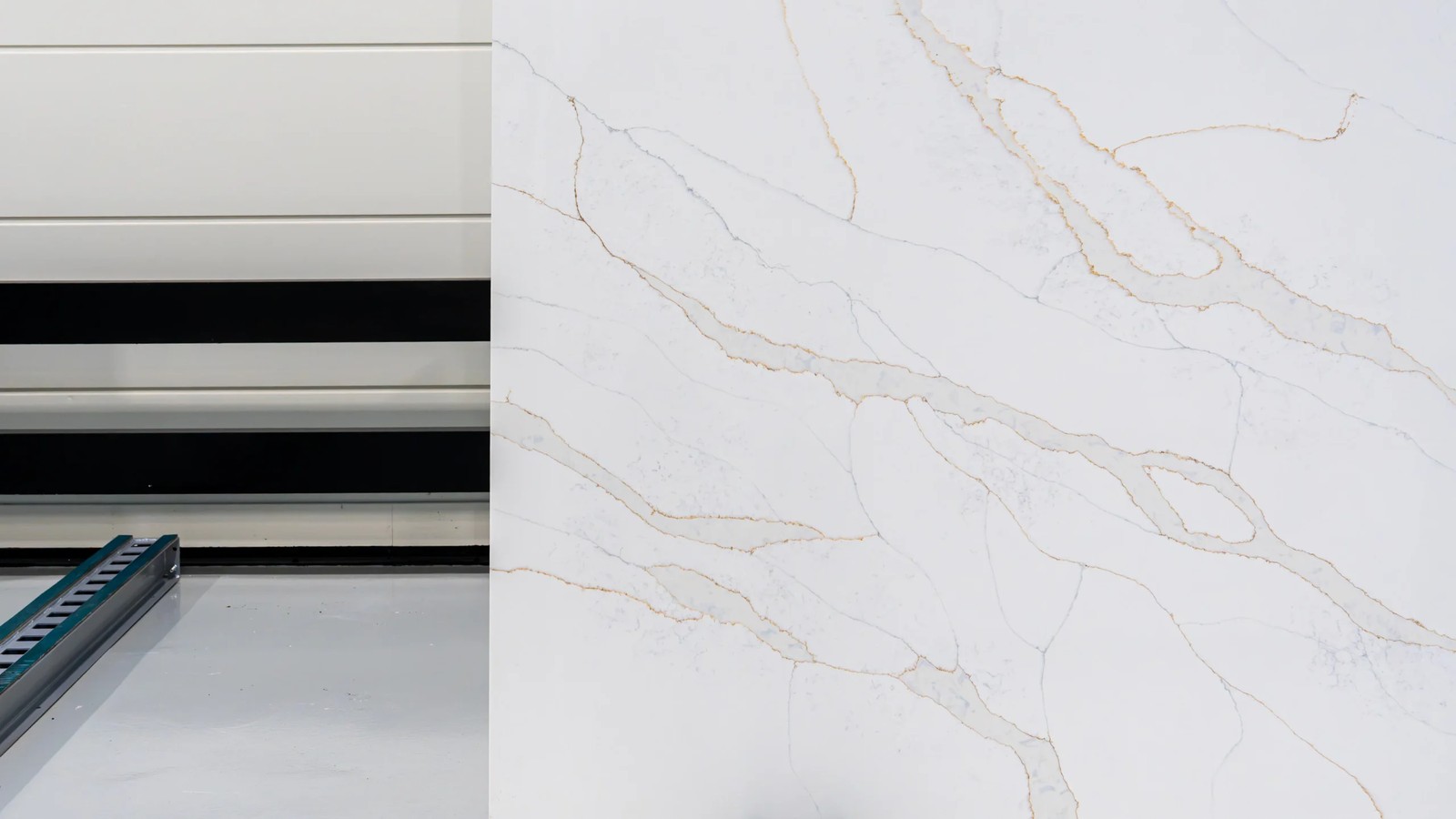Calacatta Gold white engineered stone slab angled view with natural-looking grey and gold veining