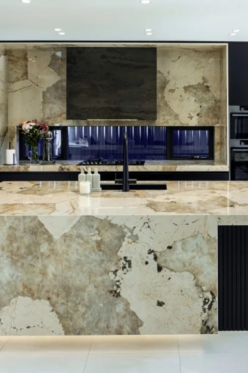 Open-plan kitchen featuring DEKTON stone surfaces and minimalist cabinetry