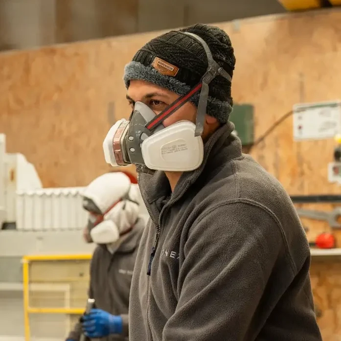 Stone fabrication specialist working in the Mo's StoneX workshop wearing protective equipment