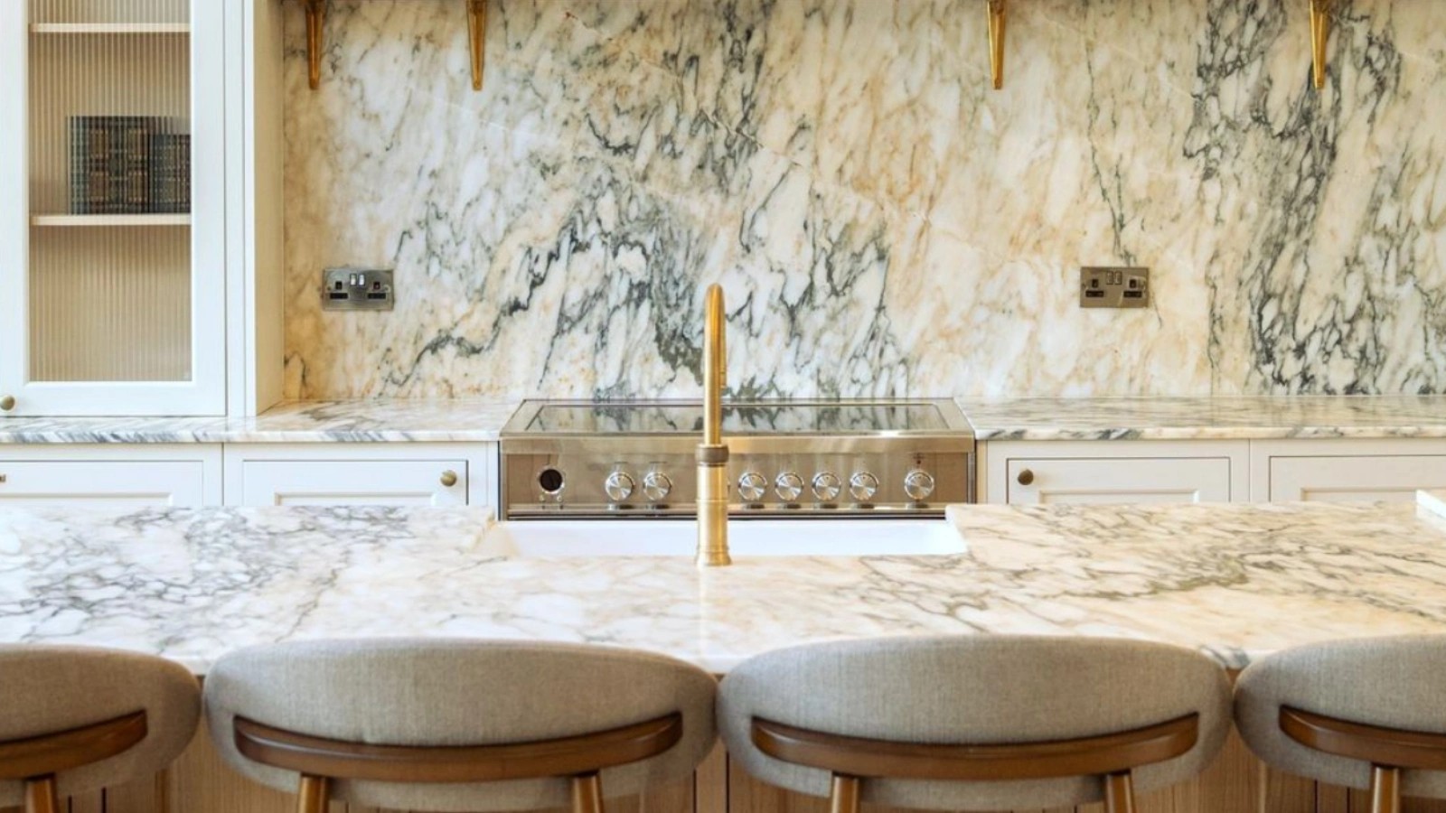 Natural marble kitchen island worktop with matching splashback