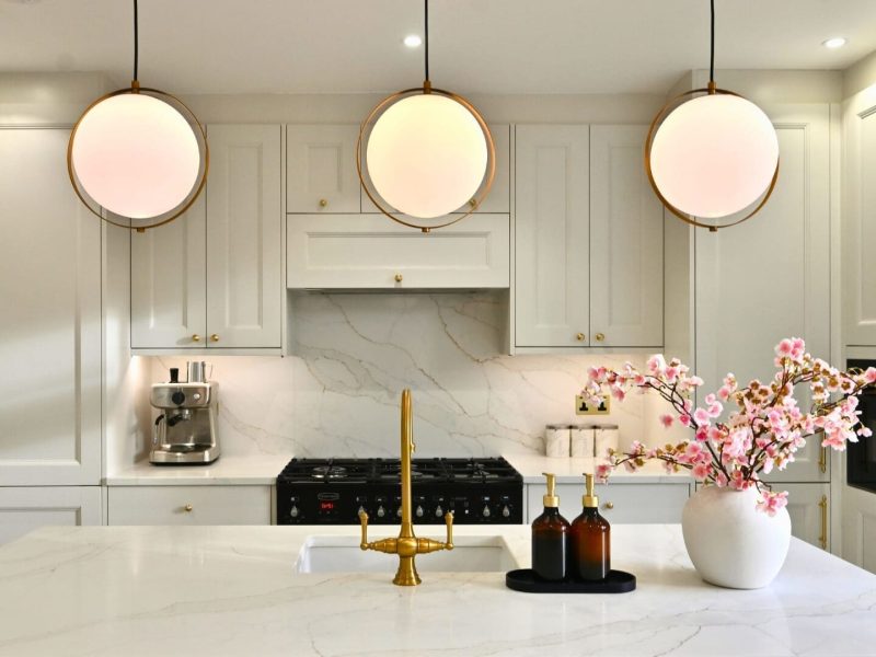 White kitchen featuring quartz splashback and matching worktops