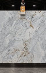 Calacatta Caldia natural marble slab with pale background and soft grey veining