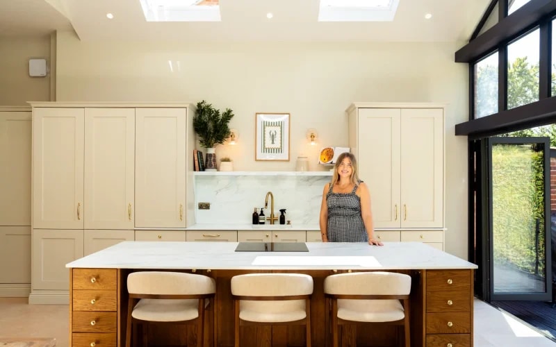 Calacatta Oro quartz worktops in a modern kitchen with cream cabinets and a wooden island